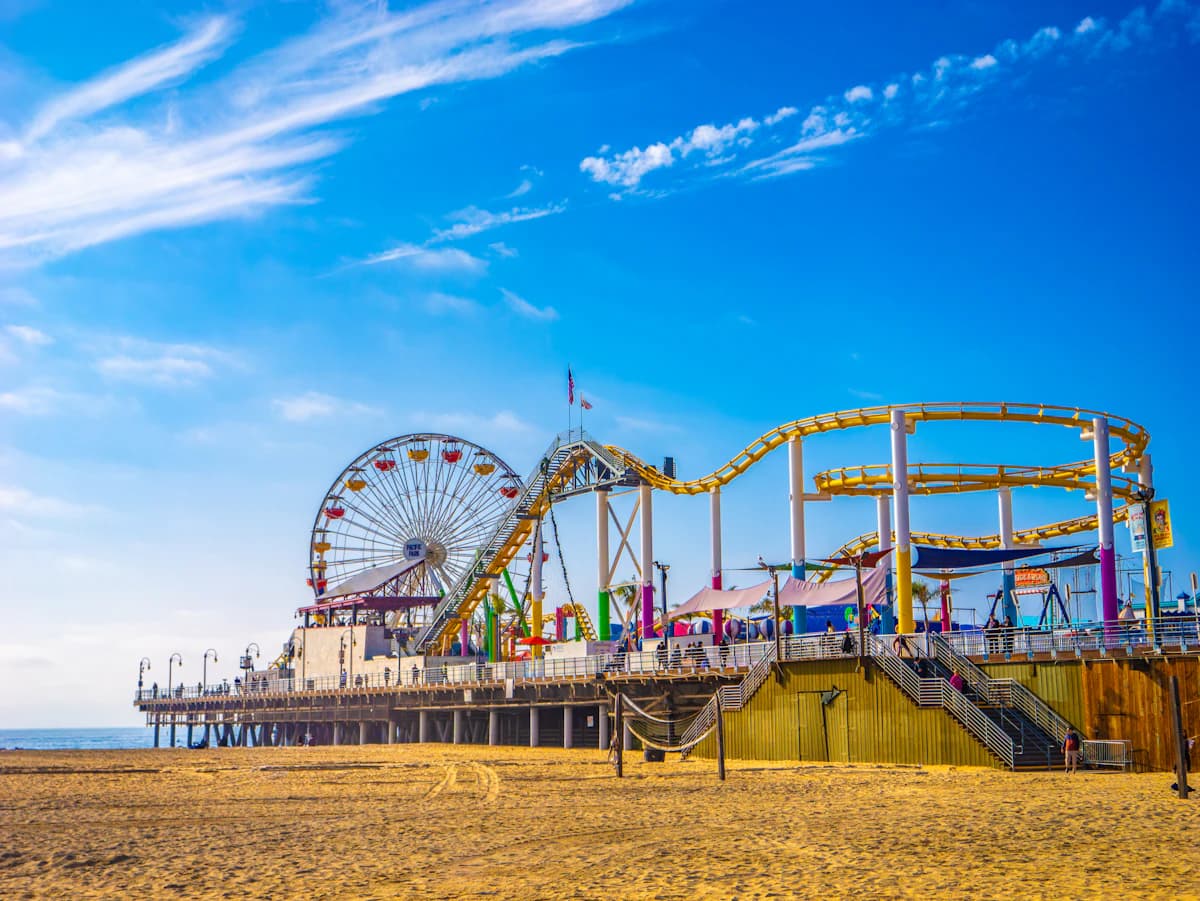 Santa Monica Pier roller coaster and rides on a sunny day