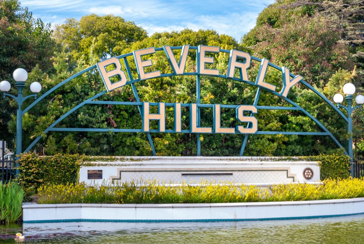 Beverly Hills sign in front of a lily pond